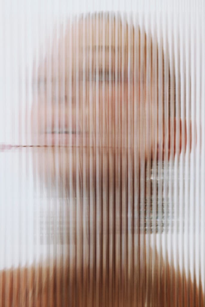 Portrait seen through fluted glass
